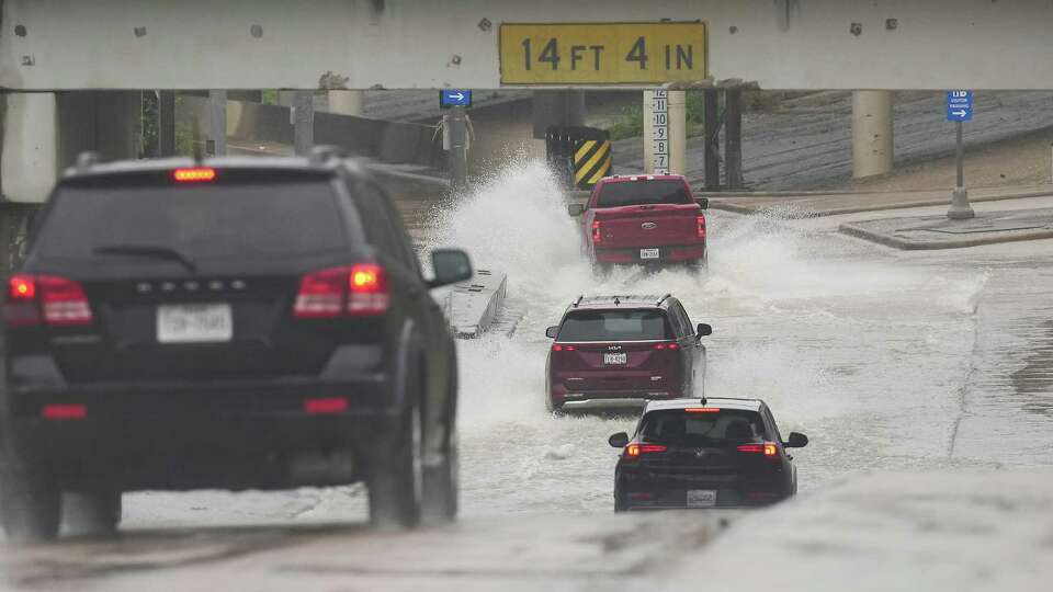 Cars try to get onto the I-10 ramp despite the rising water near downtown on Friday, July 26, 2024 in Houston.