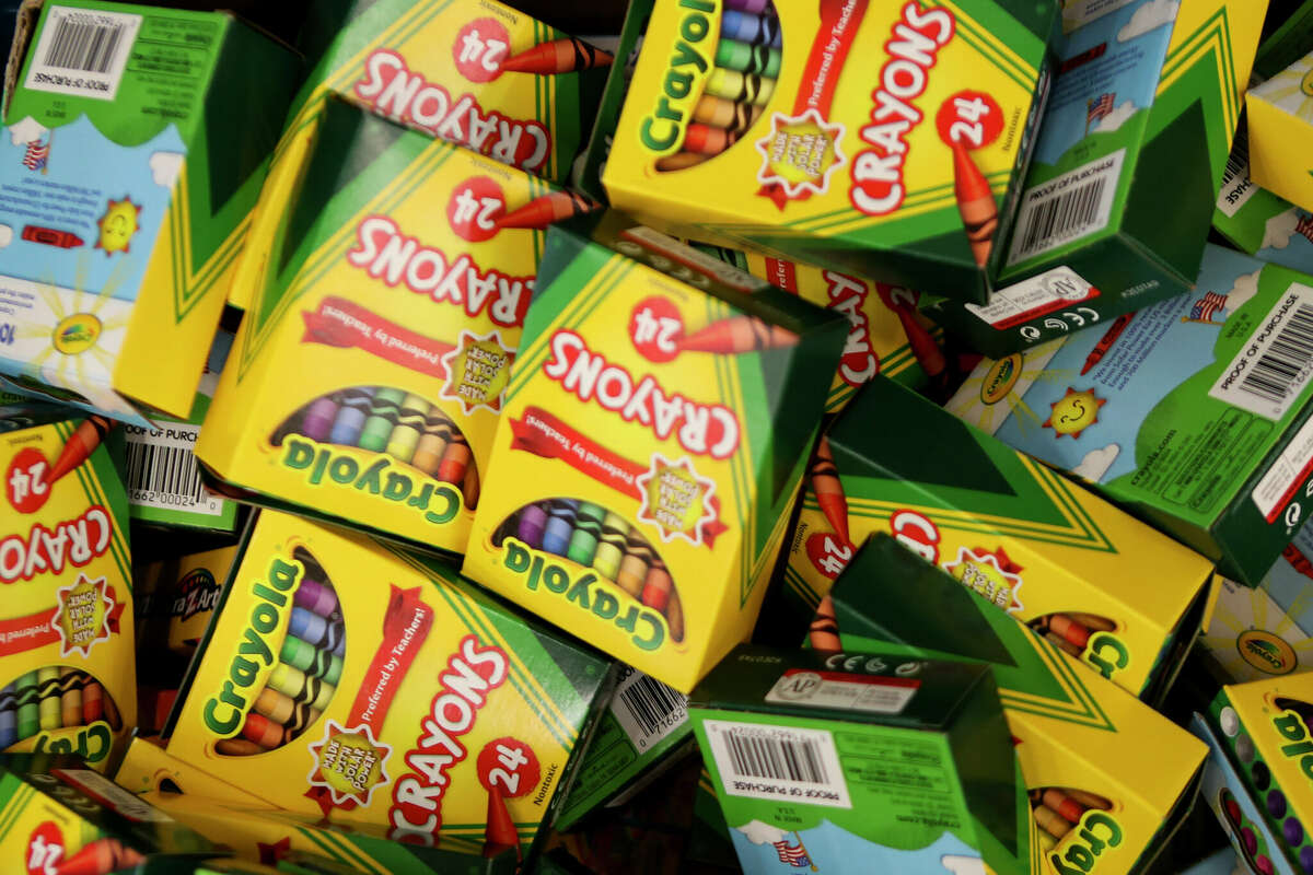 Crayons are seen as volunteers pack more than 1,500 backpacks with school supplies at Bradley Elementary School, Saturday, Aug. 5, 2023, in Spring. The annual effort helps provide supplies to students in 13 Conroe ISD schools.