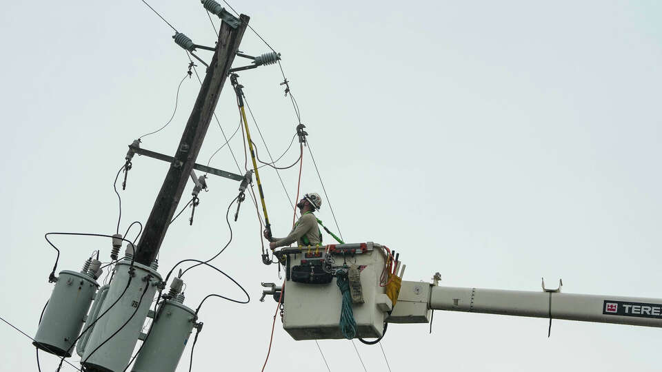 A lineman tends to fallen power lines in the East End neighborhood of Houston, days after Hurricane Beryl made landfall, on Thursday, July 11, 2024 in Houston.