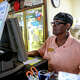 Cashier/unit manager Rose Sledge checks on an order at Chester's Hamburgers, 16609 San Pedro, in July 2024. According to a new study from OysterLink, fast food workers are the most sought-after hospitality employees in Texas.