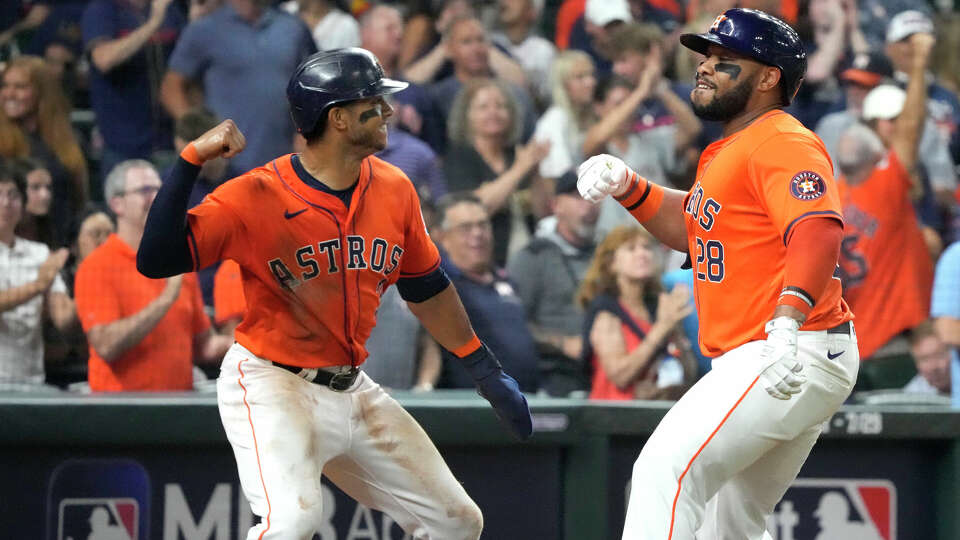 Houston Astros Jon Singleton (28) celebrates with Jeremy Peña (3) after hitting a two-run home run during the fourth inning of an MLB baseball game at Minute Maid Park on Friday, July 26, 2024, in Houston.