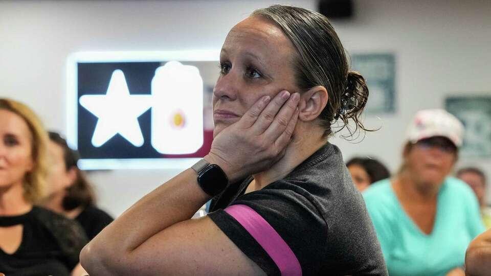 Holly Perez, 46, listens to sermon at Saltwater Revival Pirate Church at Jackies Bar and Grill on Sunday, July 28, 2024 in Kemah. Pirate Church welcomes those seeking an alternative worship experience outside more traditional churches.