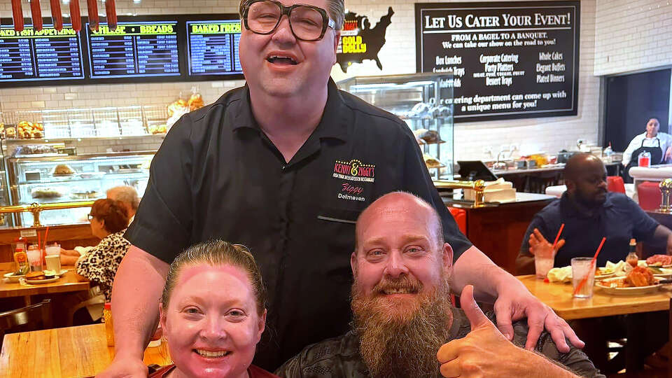 From left, Kim Maker, Ziggy Gruber and Nathan Maker pose for a photo at Kenny & Ziggy's in Houston on July 28, 2024