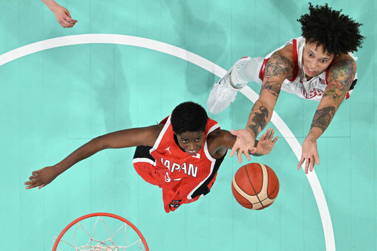 Evelyn Mawuli, of Japan, and Brittney Griner, of the Unites States, go for a rebound during a women's basketball game at the 2024 Summer Olympics, Monday, July 29, 2024, in Villeneuve-d'Ascq, France. 