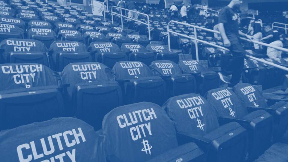 Volunteers from Reagan High School place 'Clutch City' t-shirts on the seats at Toyota Center in 2014.