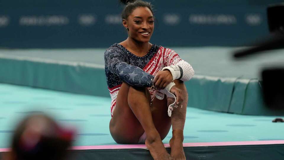 Simone Biles, of the United States, smiles during the women's artistic gymnastics team finals round at Bercy Arena at the 2024 Summer Olympics, Tuesday, July 30, 2024, in Paris, France. (AP Photo/Natacha Pisarenko)