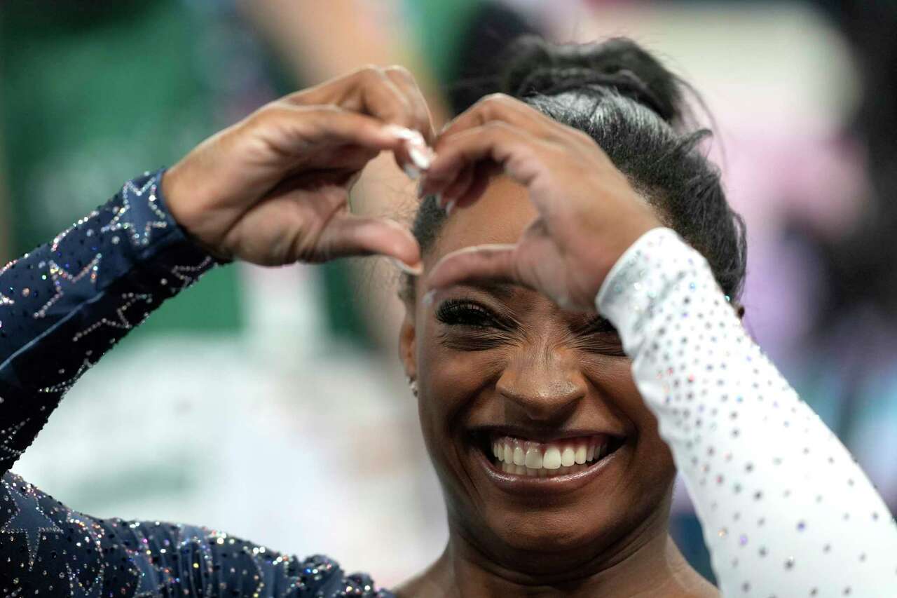 Simone Biles, of the United States, acknowledges the crowd during the women's artistic gymnastics team finals round at Bercy Arena at the 2024 Summer Olympics, Tuesday, July 30, 2024, in Paris, France. (AP Photo/Francisco Seco)