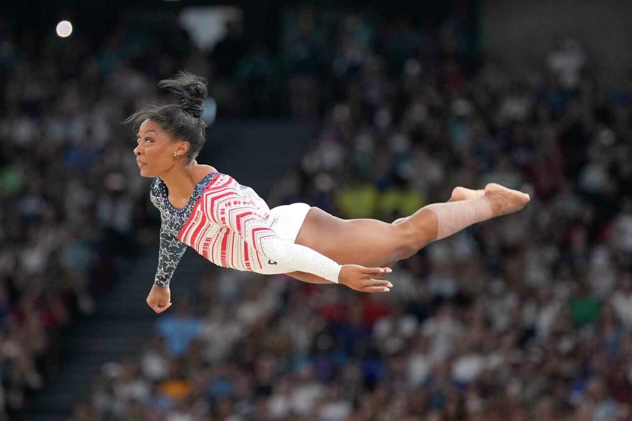 Simone Biles, of the United States, performs on the floor during the women's artistic gymnastics team finals round at Bercy Arena at the 2024 Summer Olympics, Tuesday, July 30, 2024, in Paris, France. (AP Photo/Charlie Riedel)