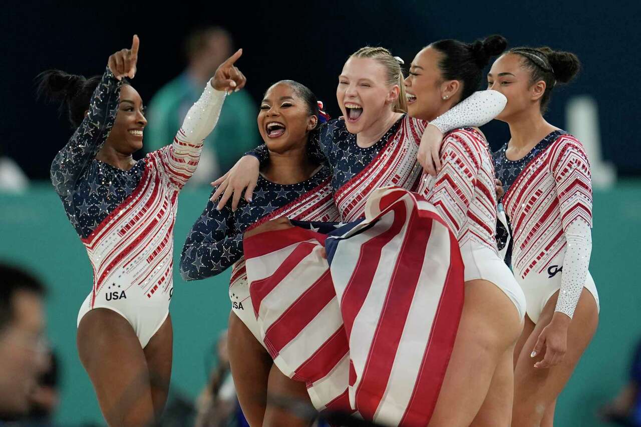 Members of Team USA celebrate after winning the gold medal during the women's artistic gymnastics team finals round at Bercy Arena at the 2024 Summer Olympics, Tuesday, July 30, 2024, in Paris, France. (AP Photo/Abbie Parr)