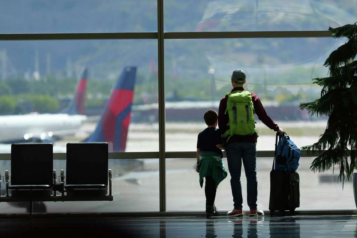 FILE - Travelers pass through Salt Lake City International Airport on May 24, 2024, in Salt Lake City. On Thursday, Aug. 1, 2024, Transportation Secretary Pete Buttigieg is expected to announce a new rule that would require airlines to do everything possible to ensure parents can sit with young children on flights.