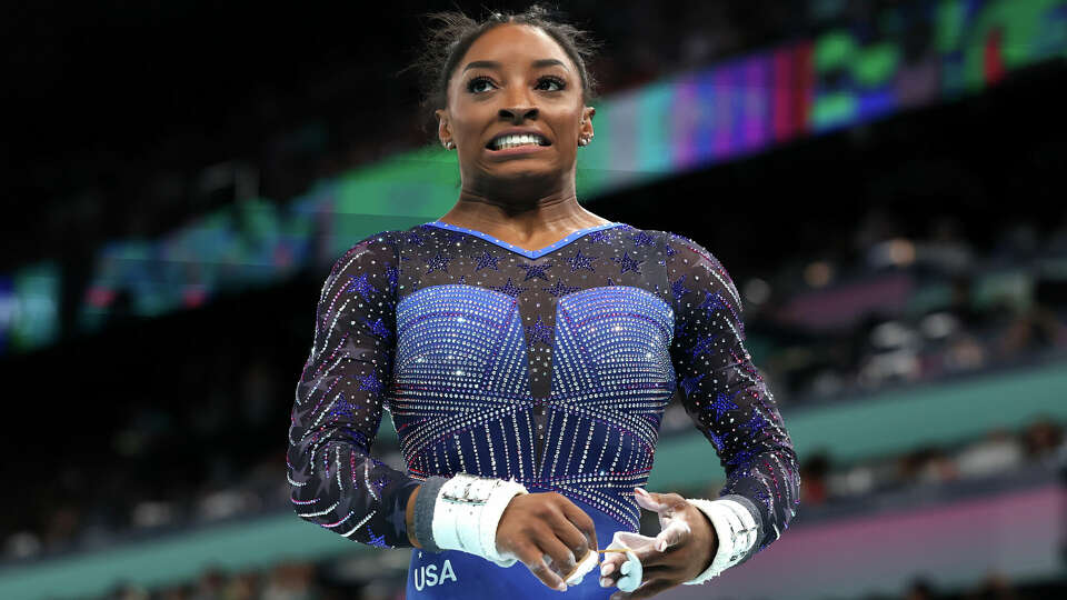 Simone Biles reacts after a disappointing routine on uneven bars.