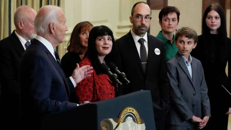 President Joe Biden delivers remarks on a prisoner swap with Russia from the State Dining Room of the White House, Thursday, Aug. 1, 2024, in Washington, as the family of hostage Evan Gershkovich, looks on.