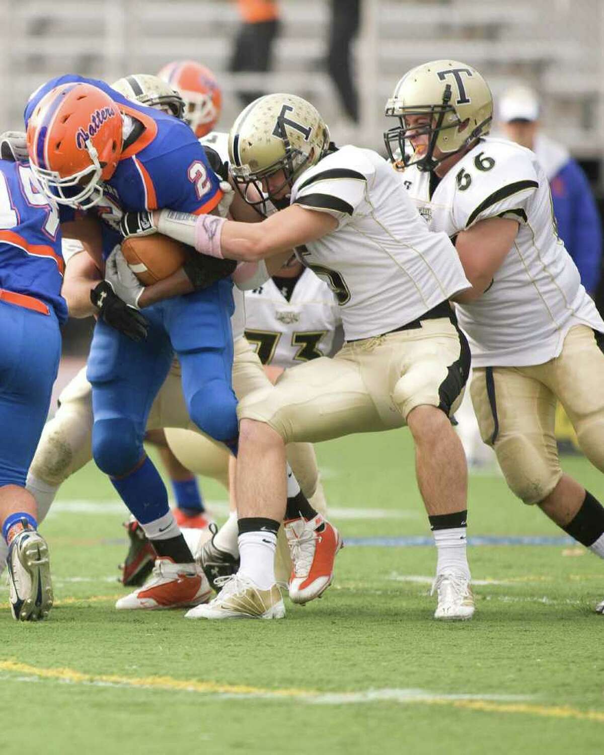 Trumbull's Tom Pauciello (5) tries to strip the ball from Danbury's Aaron Dixon during their FCIAC game Saturday, Oct. 30, 2010, at Danbury High School.