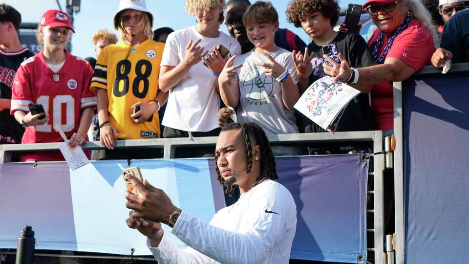 Houston Texans quarterback C.J. Stroud takes a photo with fans before the Hall of Fame Game on Thursday, Aug. 1, 2024 in Canton, Ohio.