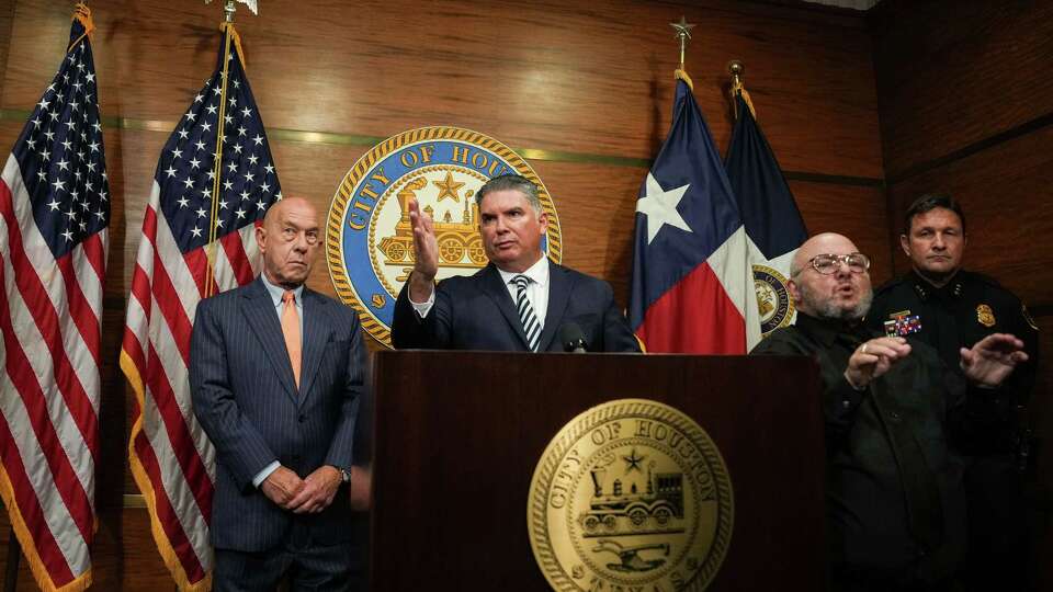 Noe Diaz, the incoming chief of the Houston Police Department, speaks at the podium during a press conference with Mayor John Whitmire, left, and interim HPD Chief Larry Satterwhite, right, during a press conference Diaz as the new chief Friday, Aug. 2, 2024, at Houston City Hall in Houston.