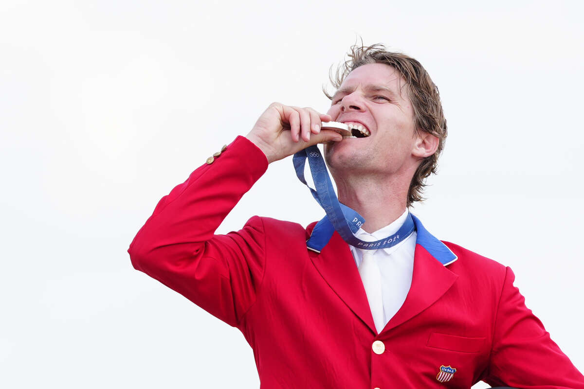 USA's' Karl Cook celebrates with their silver medal during the ceremony of the Jumping Team Final at the Chateau de Versailles on the seventh day of the 2024 Paris Olympic Games in France. Picture date: Friday August 2, 2024.