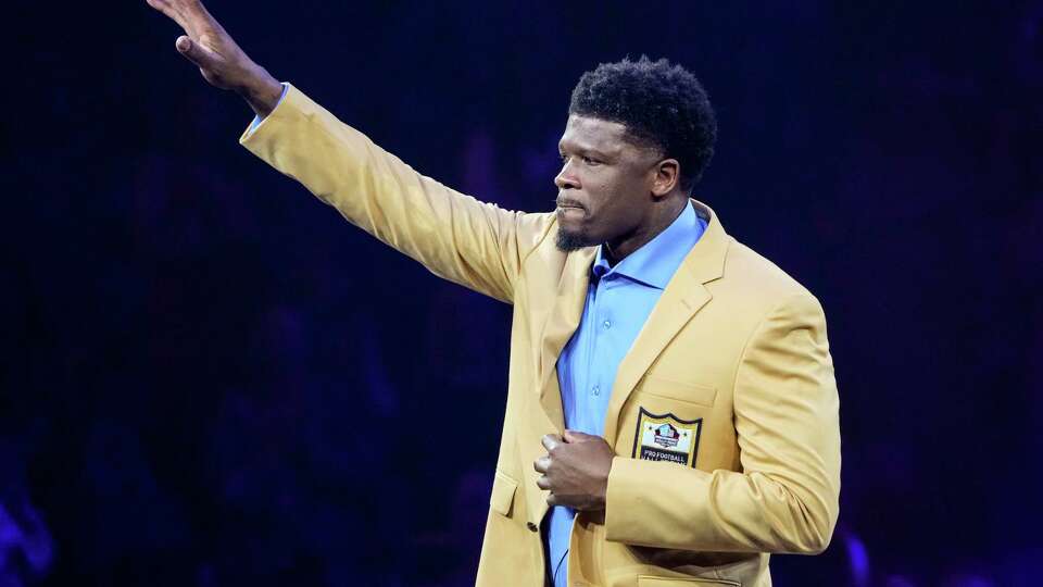 Andre Johnson, former Houston Texans wide receiver and member of the Pro Football Hall of Fame Class of 2024, waves after receiving his gold jacket during a ceremony at the Canton Memorial Civic Center on Friday, Aug. 2, 2024 in Canton, Ohio. Johnson is the first Texans player to be inducted into the Hall of Fame.