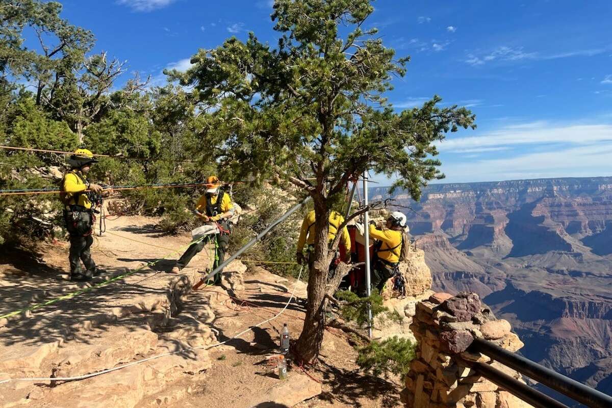 A man attempting a BASE jump died at the Grand Canyon on Aug. 1, 2024, park officials said. Here, a recovery team attempts to reach the body.