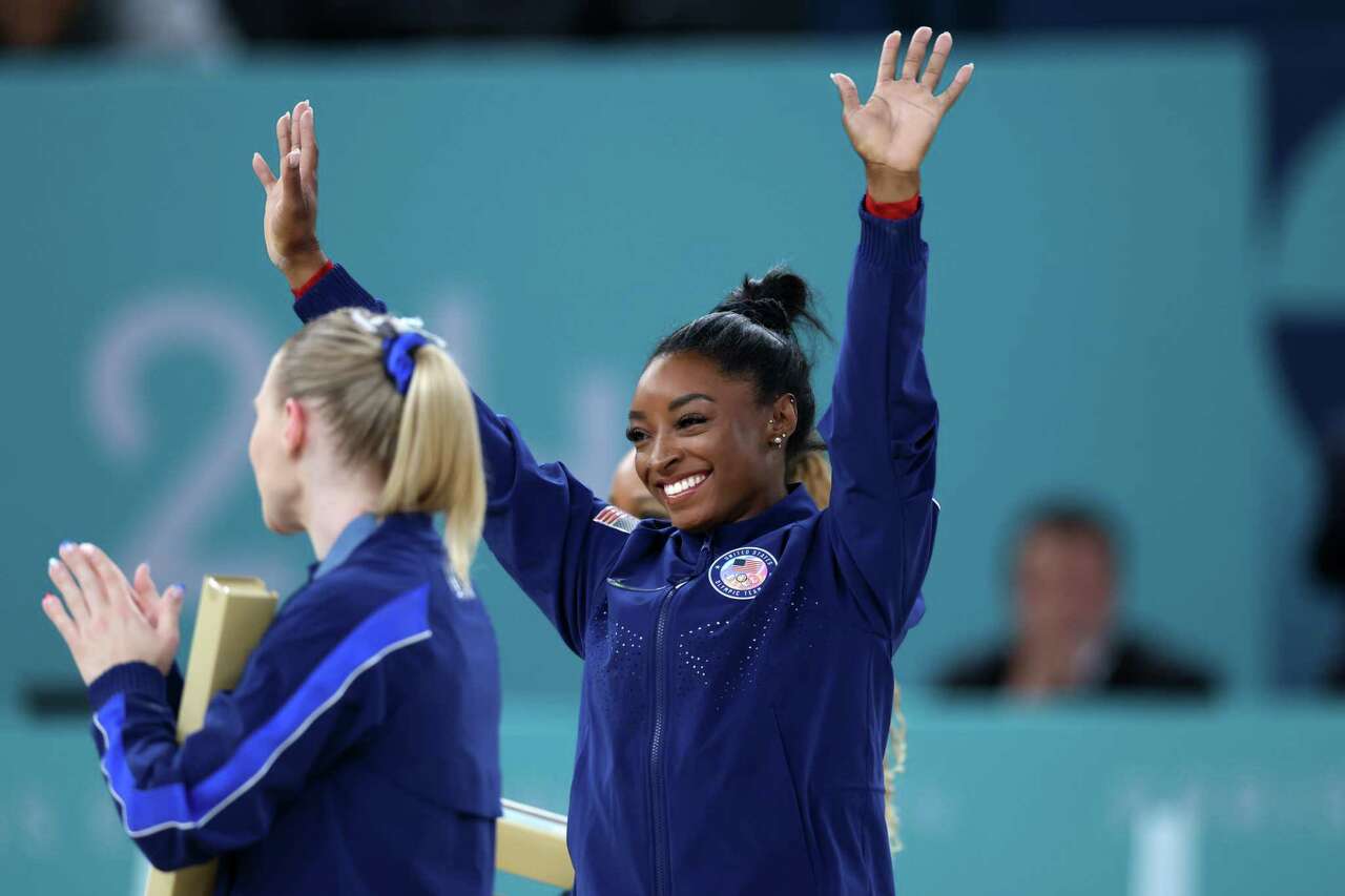 PARIS, FRANCE - AUGUST 03: Gold medalist Simone Biles of Team United States celebrates on the podium during the medal ceremony for the Artistic Gymnastics Women's Vault Final on day eight of the Olympic Games Paris 2024 at Bercy Arena on August 03, 2024 in Paris, France.