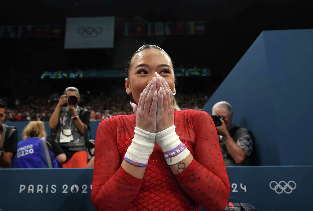 PARIS, FRANCE - AUGUST 04: Sunisa Lee of Team United States celebrates winning the Bronze medal during the Artistic Gymnastics Women's Uneven Bars Final on day nine of the Olympic Games Paris 2024 at Bercy Arena on August 04, 2024 in Paris, France.