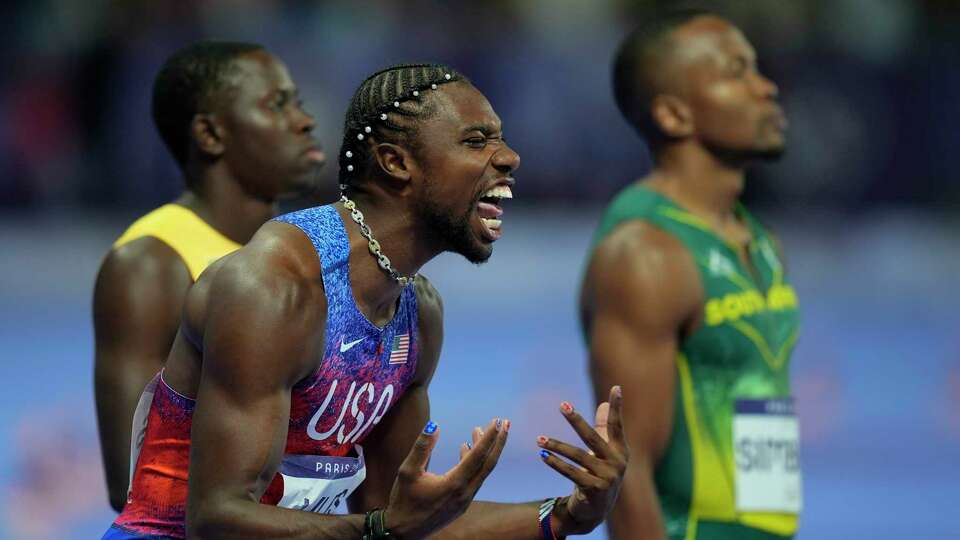 Noah Lyles of the United States shouts as he prepares for the start of the men's 100-meter final at the 2024 Summer Olympics, Sunday, Aug. 4, 2024, in Saint-Denis, France. (AP Photo/Rebecca Blackwell)