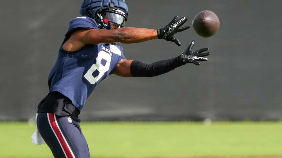 Houston Texans wide receiver John Metchie III reaches out to make a catch during an NFL training camp Tuesday, July 30, 2024, in Houston.