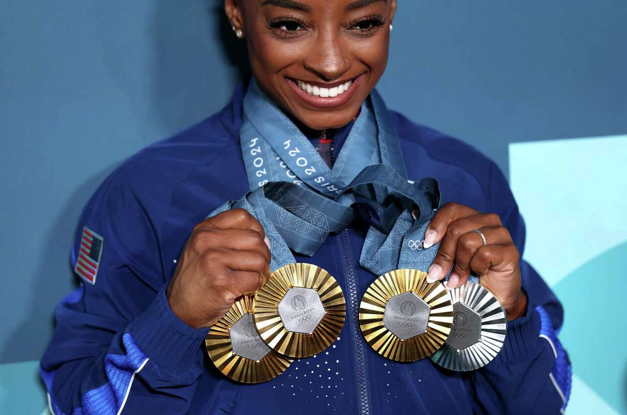 PARIS, FRANCE - AUGUST 05: Simone Biles of Team United States poses with her Paris 2024 Olympic medals following the Artistic Gymnastics Women's Floor Exercise Final on day ten of the Olympic Games Paris 2024 at Bercy Arena on August 05, 2024 in Paris, France.