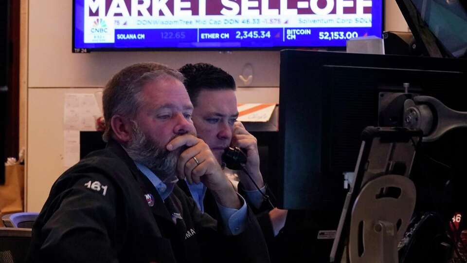 A pair of traders work on the floor of the New York Stock Exchange, Monday, Aug. 5, 2024. Nearly everything on Wall Street is tumbling as fear about a slowing U.S. economy worsens and sets off another sell-off for financial markets around the world. (AP Photo/Richard Drew)