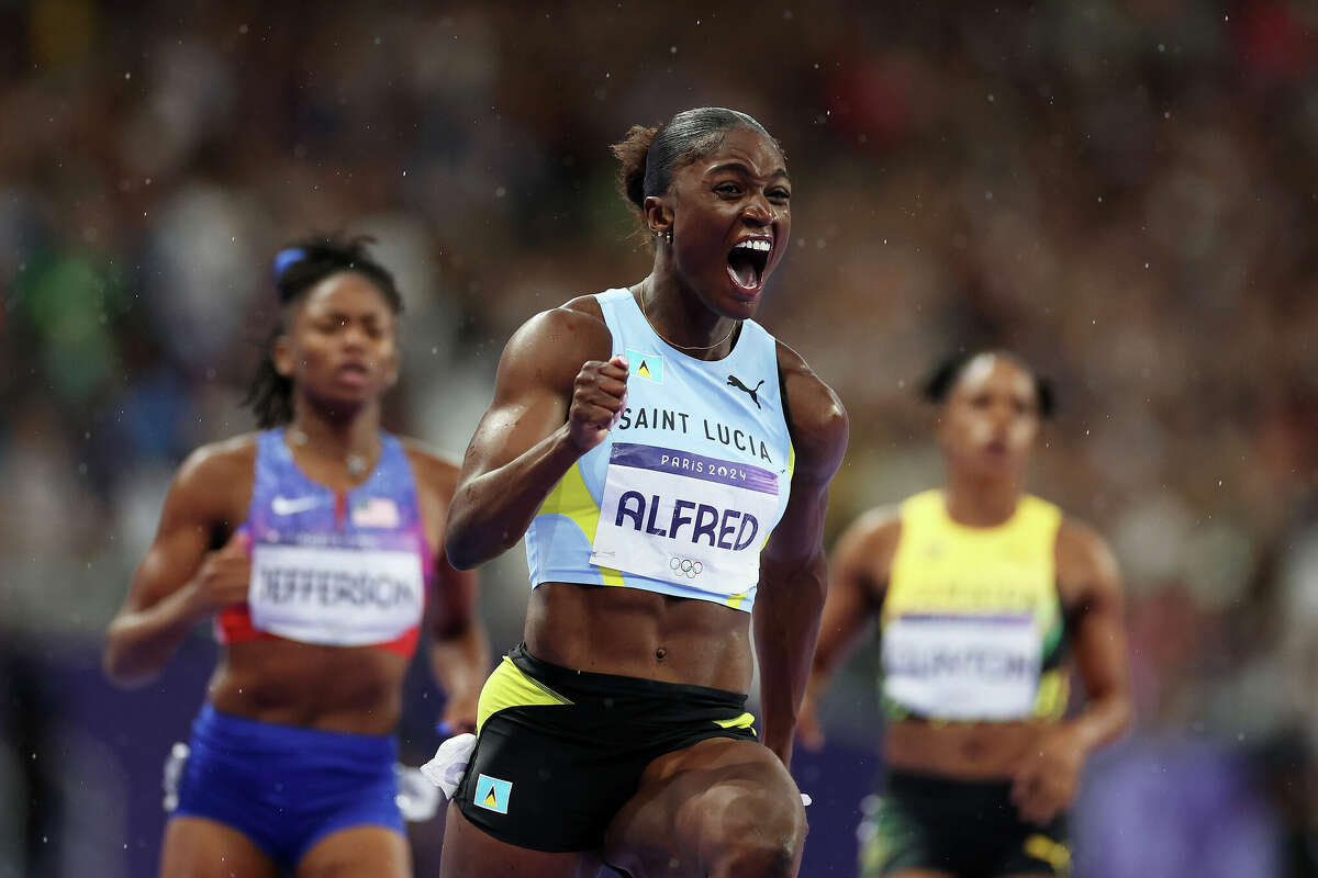 Julien Alfred of Team Saint Lucia celebrates winning the gold medal during the Women's 100m Final on day eight of the Olympic Games Paris 2024 at Stade de France on August 03, 2024 in Paris, France. (