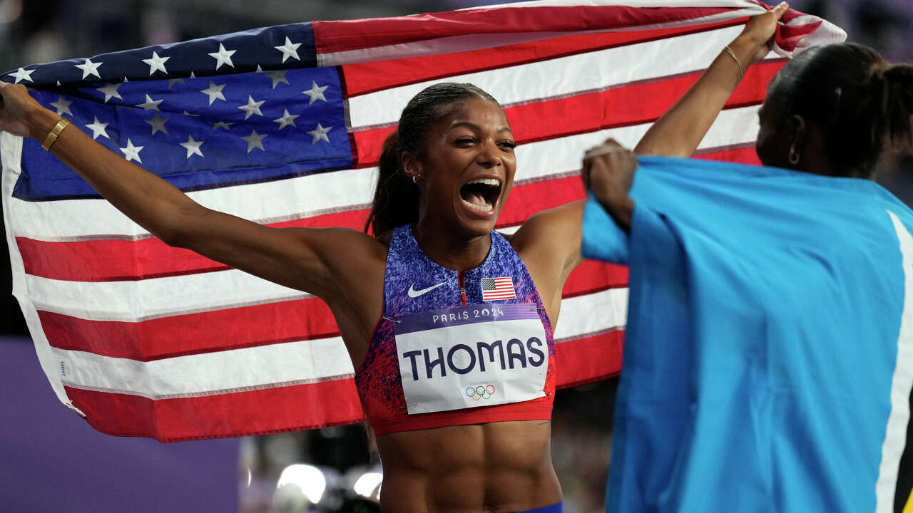 Gabrielle Thomas, of the United States, celebrates with silver medalist Julien Alfred, of Saint Lucia, after winning the gold medal in the women's 200 meters final at the 2024 Summer Olympics, Tuesday, Aug. 6, 2024, in Saint-Denis, France. 