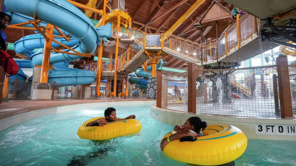 Kids float in Crooked Creek lazy river during the grand opening Great Wolf Lodge Gulf Coast on Wednesday, Aug. 7, 2024 in Webster. The adventure park and hotel, featuring a 92,000 square foot water park, is the first of its kind to open in the Houston area.