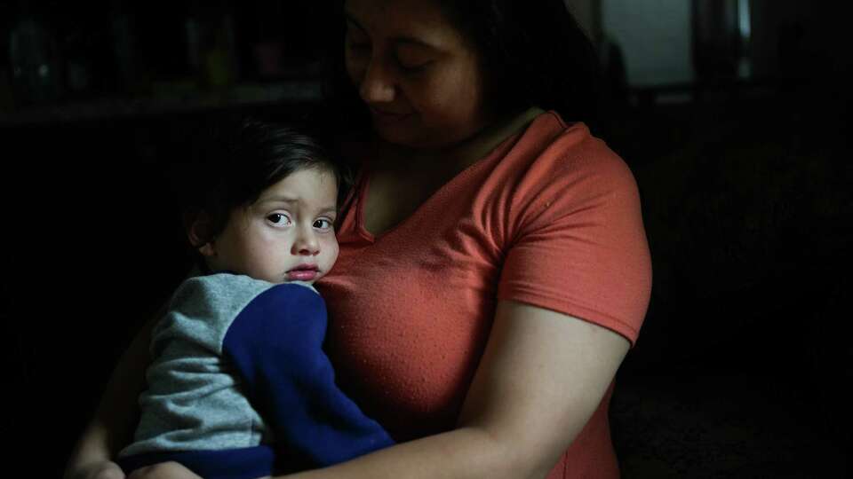 Arizai Gonzales with her son, Daniel Fuentes, 2, who is diagnosed with autism in their home on Wednesday, Aug. 7, 2024 in Cleveland. Daniel’s speech language pathologist was laid off from Texas Children’s Hospital on Tuesday as part of system-wide layoffs. Gonzales is concerned that the progress her son has made over the last year will be lost as they try to find another therapist.