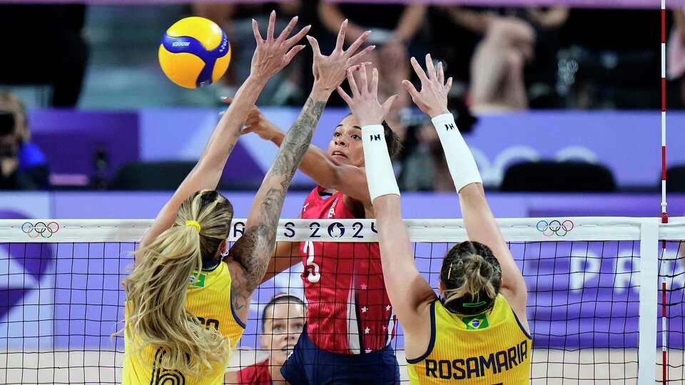 United States' Avery Skinner (3) tries to hit past Brazil's Thaisa Daher (6) and Rosamaria Montibeller (7) during a semifinal women's volleyball match at the 2024 Summer Olympics, Thursday, Aug. 8, 2024, in Paris, France. (AP Photo/Alessandra Tarantino)