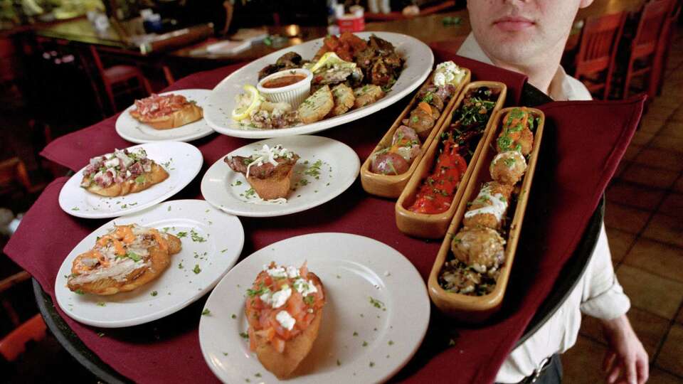 CONTACT FILED: MI LUNA-HOUSTON Bly Bruckner, manager of Mi Luna, shows off some of their various tapas for Dining Guide cover which the restaurant offers, Thursday, June 20, 2002 in Houston. This is for a story on what businesses do to bring in customers during off-hours. CHRISTOBAL PEREZ/HOUSTON CHRONICLE. HOUCHRON CAPTION (06/28/2002): Bly Bruckner, manager of Mi Luna, displays a variety of tapas, available at reduced prices during the restaurant's off-hours.