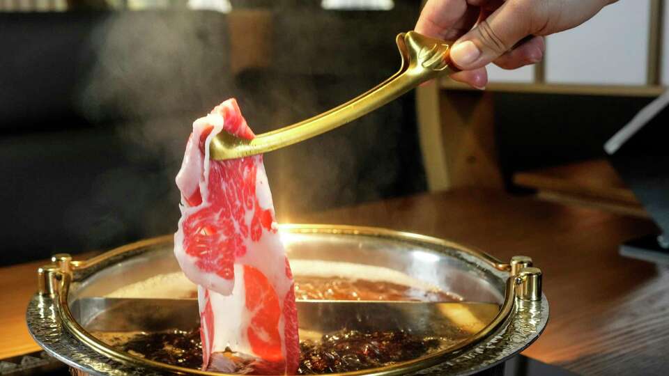 A5 Wagyu brisket is cooked at the table at Mikiya Wagyu Shabu House on Thursday, Aug. 8, 2024 in Houston.