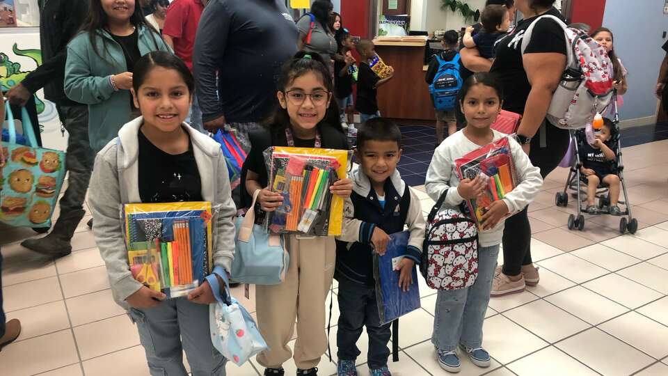 At Armstrong Elementary School, children were greeted with cheers, music and a box of school supplies.