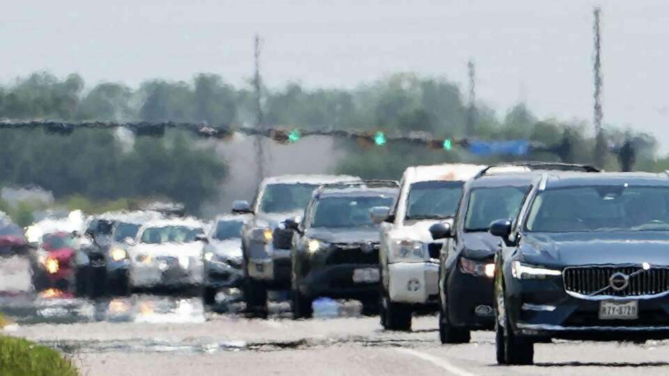 Traffic drives down Texas 6 in the afternoon heat Wednesday, Aug. 7, 2024, near the corner of Voss Road and Texas 6 in Sugar Land.