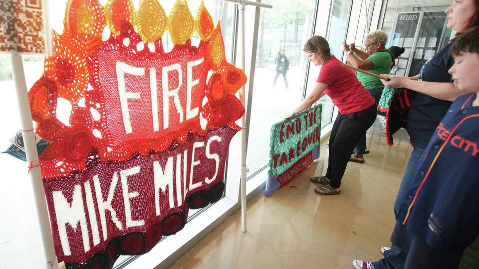 Protesters knit and crochet before an HISD board meeting on Thursday, Aug. 8, 2024 in Houston. The board is expected to vote on the $4.4 billion school bond package.