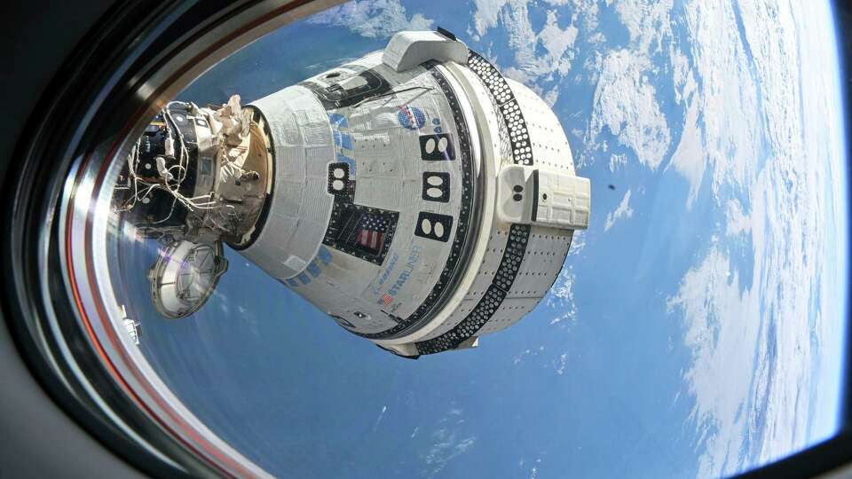 This photo provided by NASA shows Boeing's Starliner spacecraft which launched astronauts Butch Wilmore and Suni Williams to the International Space Station docked to the Harmony module's forward port on July 3, 2024, seen from a window on the SpaceX Dragon Endeavour spacecraft docked to the adjacent port. 