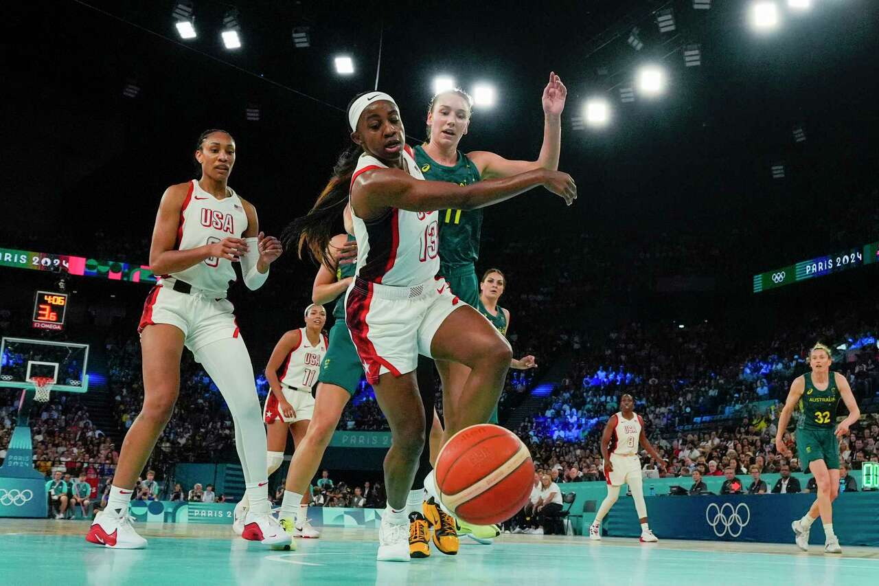 United States' Jackie Young (13) chases down the ball against Australia during a women's semifinal basketball game at Bercy Arena at the 2024 Summer Olympics, Friday, Aug. 9, 2024, in Paris, France. (AP Photo/Michael Conroy)