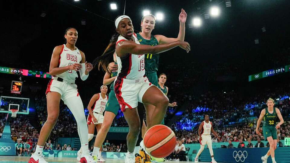 United States' Jackie Young (13) chases down the ball against Australia during a women's semifinal basketball game at Bercy Arena at the 2024 Summer Olympics, Friday, Aug. 9, 2024, in Paris, France. (AP Photo/Michael Conroy)