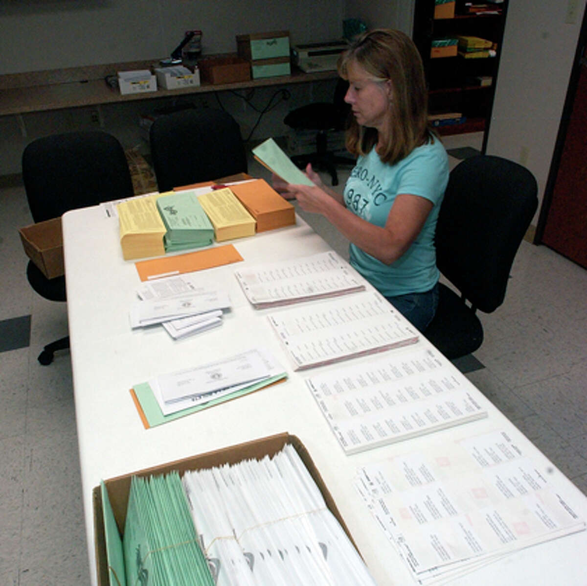 Tina Leverett, the Elections Administrator in Orange County, works through lunch getting mail-in ballots stuffed and ready to be mailed out to people who have changed address due to Hurricane Ike. Dave Ryan/The Enterprise
