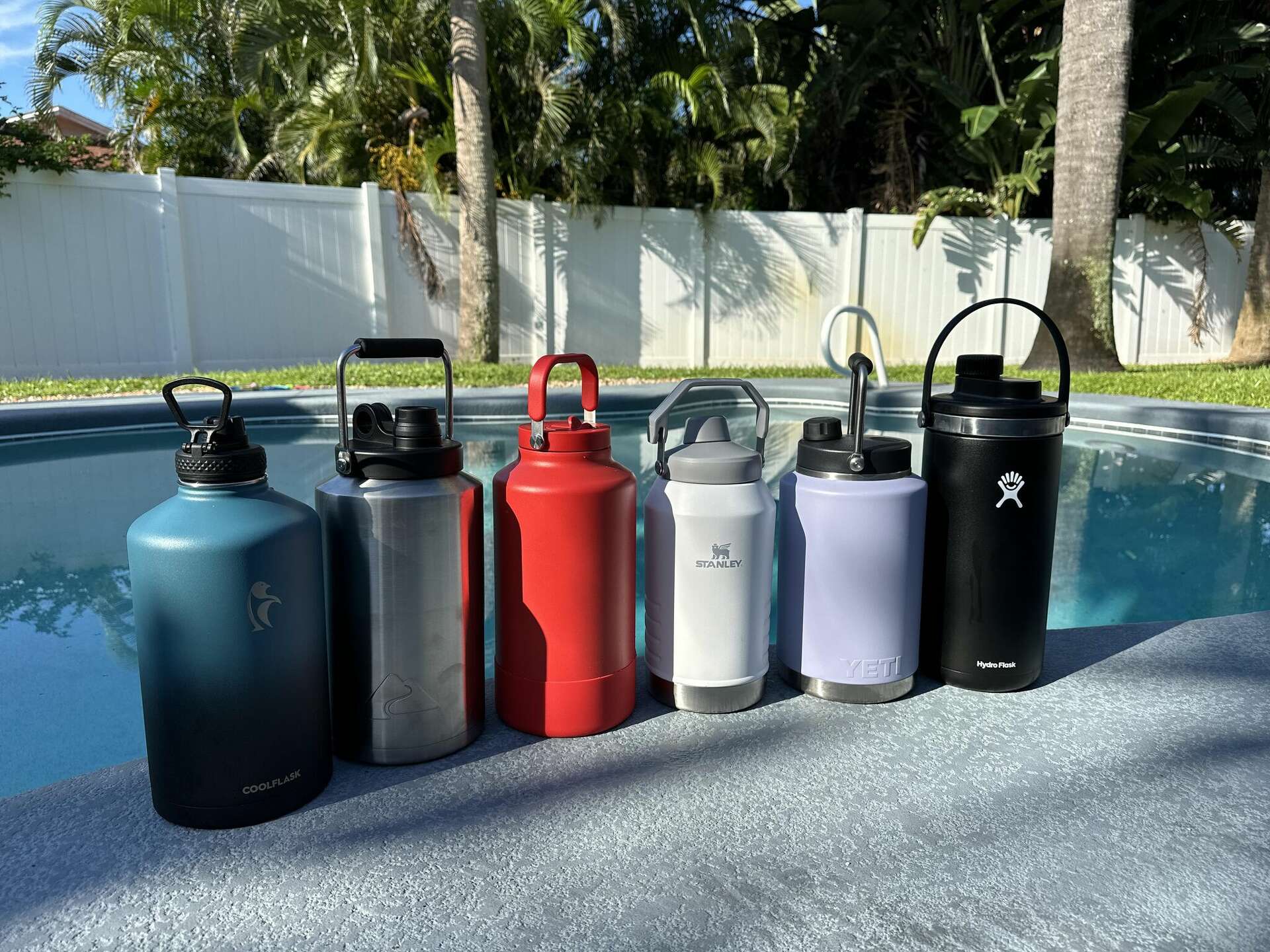 Side-by-side comparison of top gallon water bottles showing different designs and features