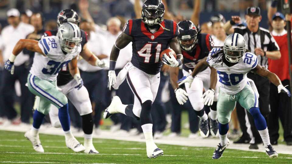 Houston Texans running back Cierre Wood (41) breaks away between Dallas Cowboys defensive backs Jeff Heath (38) and B.W. Webb (20) during the first quarter of an NFL pre-season football game at AT&T Stadium Thursday, Aug. 29, 2013, in Arlington.