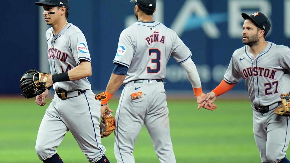 Houston Astros left fielder Mauricio Dubon (14), Jeremy Pena (3), and Jose Altuve (27) celebrate after the team defeated the Tampa Bay Rays during a baseball game Wednesday, Aug. 14, 2024, in St. Petersburg, Fla. (AP Photo/Chris O'Meara)