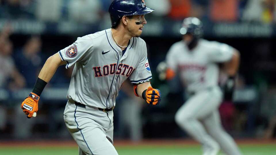 Houston Astros' Mauricio Dubon watches his RBI single off Tampa Bay Rays relief pitcher Garrett Cleavinger as Pedro Leon, right, scores during the 10th inning of a baseball game Wednesday, Aug. 14, 2024, in St. Petersburg, Fla. (AP Photo/Chris O'Meara)