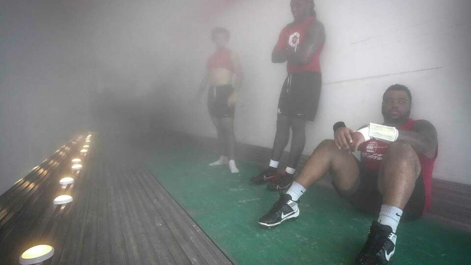 University of Houston football player Demetrius Hunter sits inside the Cougars’ “Club Ice” cooling unit after practice on Thursday, Aug. 15, 2024 in Houston. Cougars wanting to counter the effects of practicing in the Houston heat can step into a container unit that's kept between zero and minus-8 degerees. They players go into the cold for three minute stretches each time.