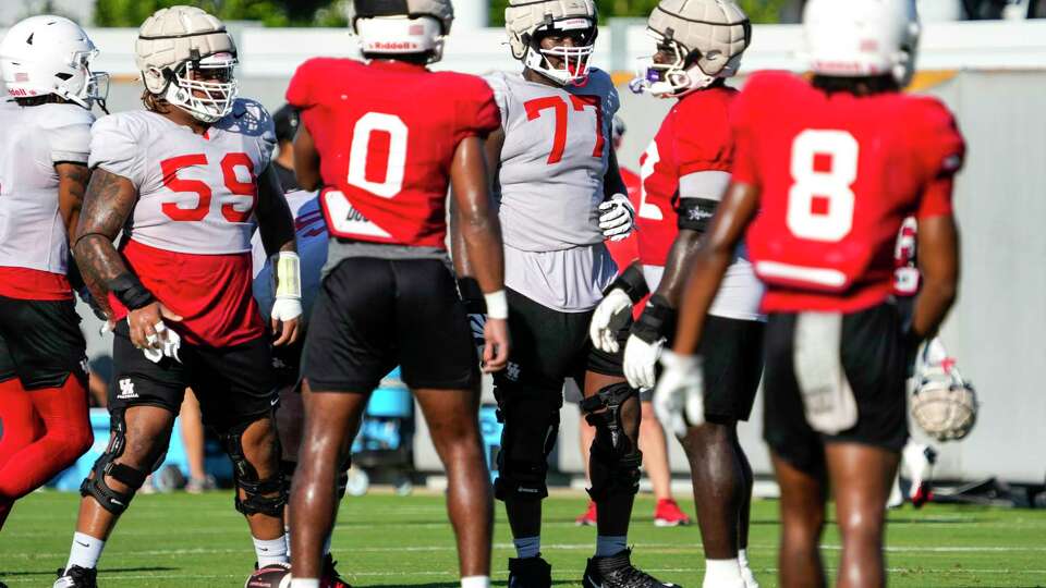 Houston offensive lineman Demetrius Hunter (59) and David Ndukwe (77) line up to run a play during practice on Thursday, Aug. 15, 2024 in Houston. The Cougars open their season on Aug. 31 at home against UNLV.