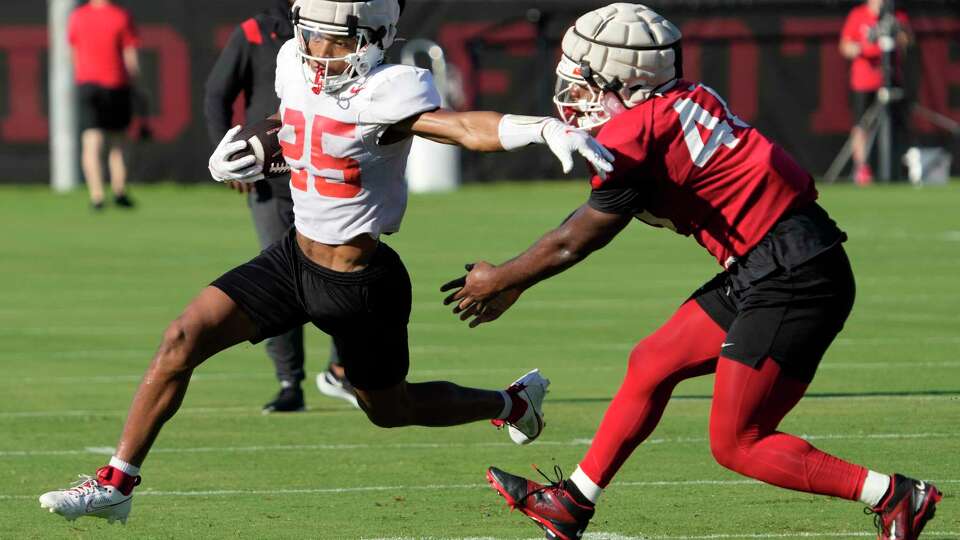 Houston running back DJ Butler (25) runs the ball with Torren Coppage-El defending during practice on Thursday, Aug. 15, 2024 in Houston. The Cougars open their season on Aug. 31 at home against UNLV.