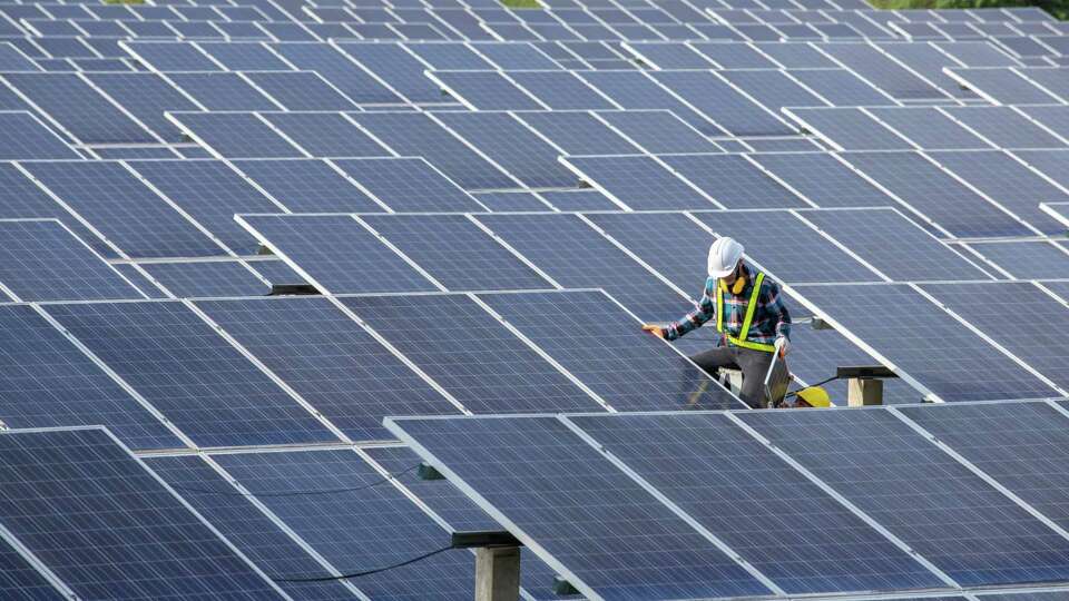 Asian engineer working on checking equipment in solar power plant, Pure energy, Renewable energy